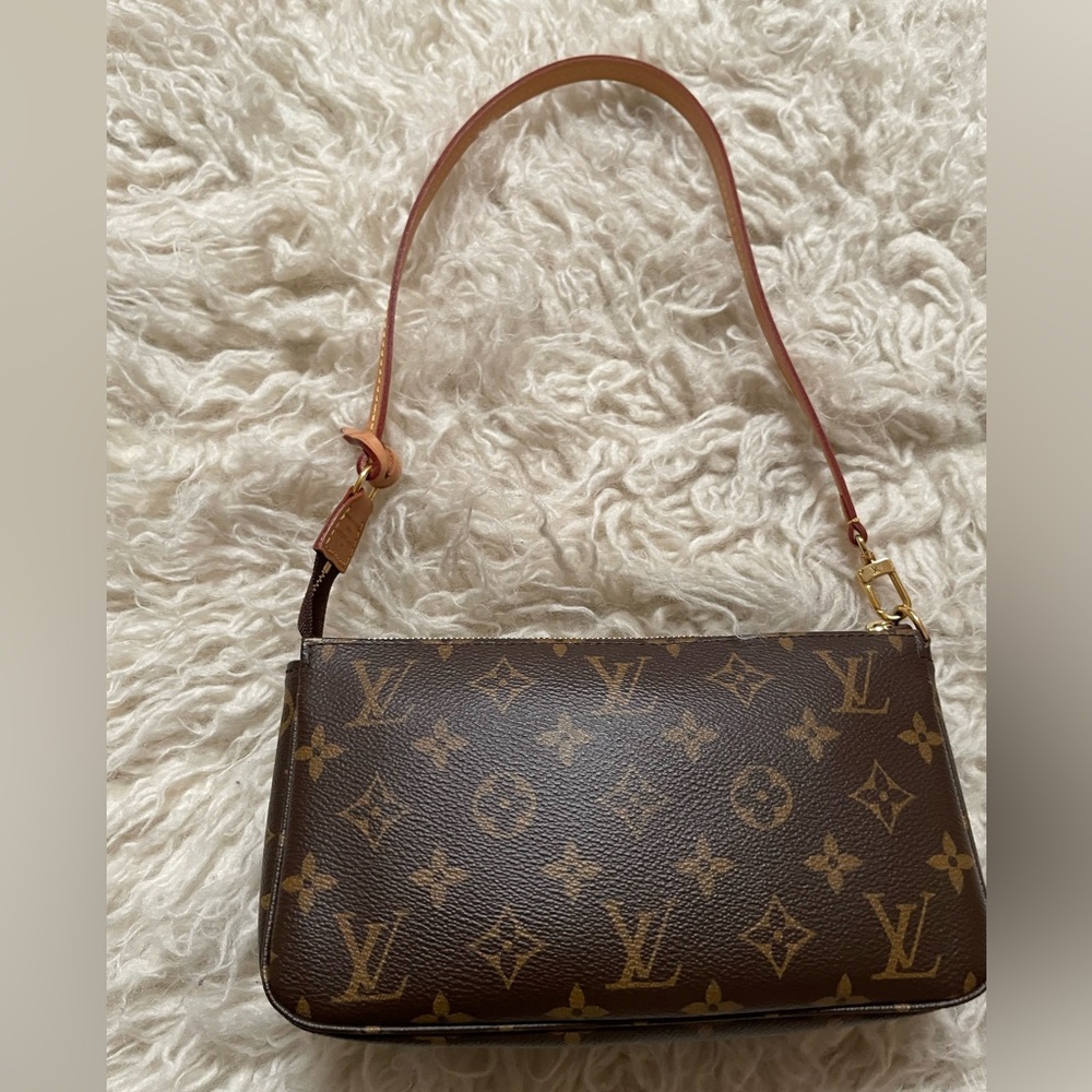 Louis Vuitton pouchette. Newer with longer strap. Sells at LV for $1660